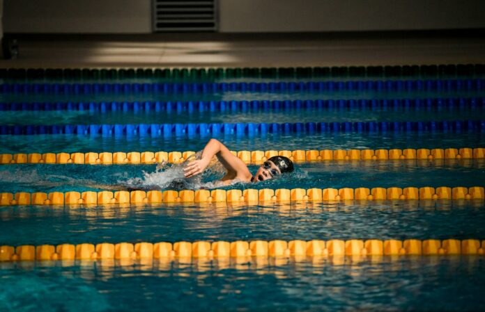 Photo by Jonathan Chng person diving in pool