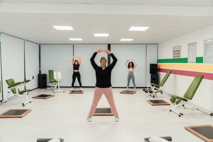 a group of people doing exercises in a room