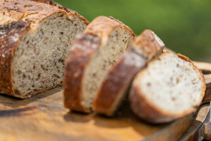 Photo by Bon Vivant a loaf of bread sitting on top of a cutting board