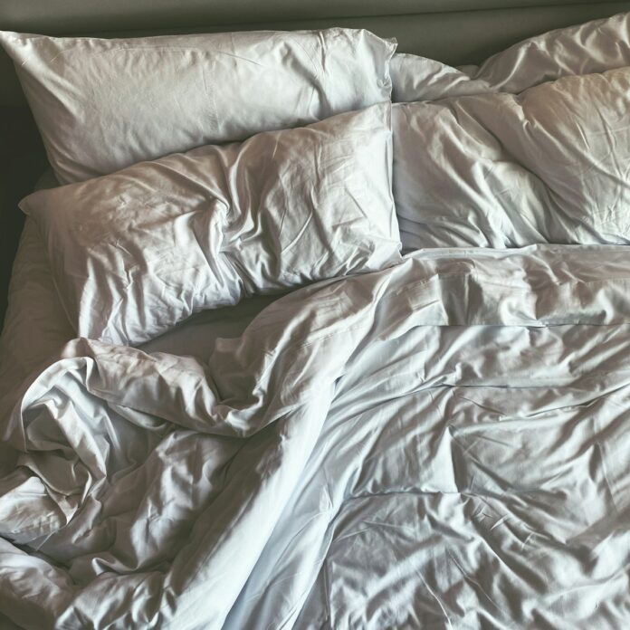 a bed with a white sheet
