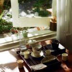 만성피로, 작은 습관 변화로 지친 일상에 활력을 Tea set arranged on a wooden tray by the window.